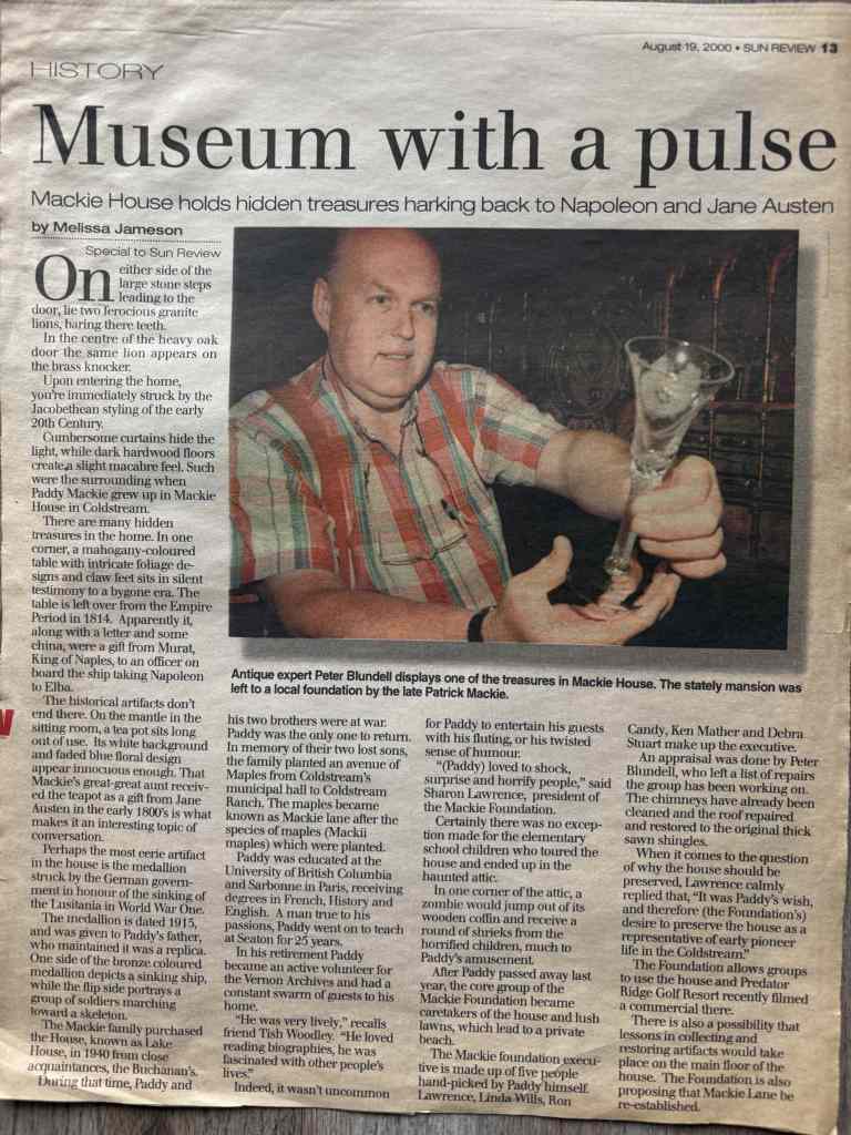 Headline: "Museum with a pulse" Photo of a man holding up a small glass or ceramic figurine toward the camera inside a museum-like room, surrounded by display cases and artifacts